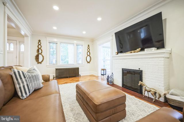 a living room with furniture fireplace and flat screen tv