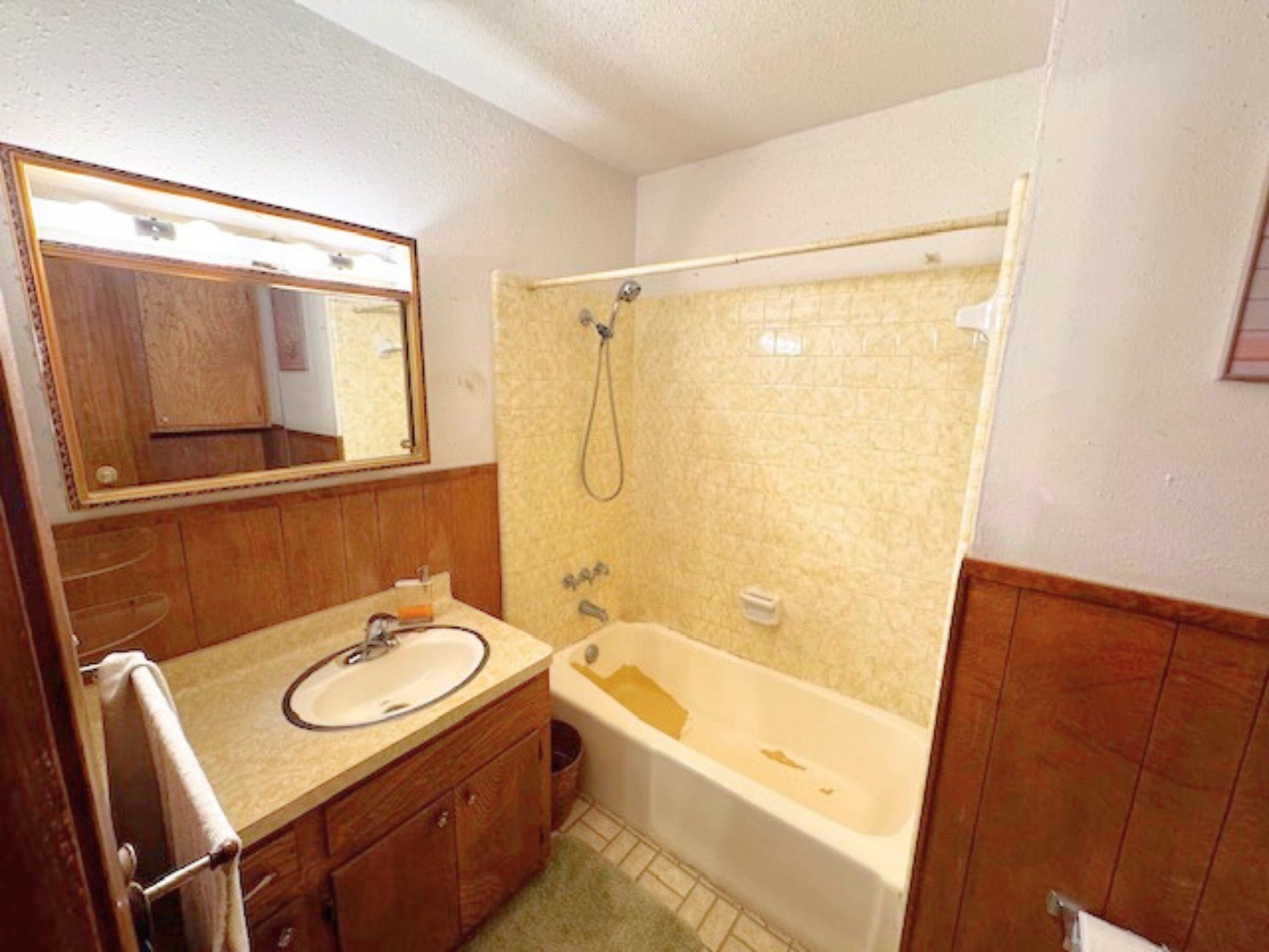 4345 Treadway Road Beaumont, TX 77708 - Photo 14 of 21 a bathroom with a sink a mirror and a bathtub