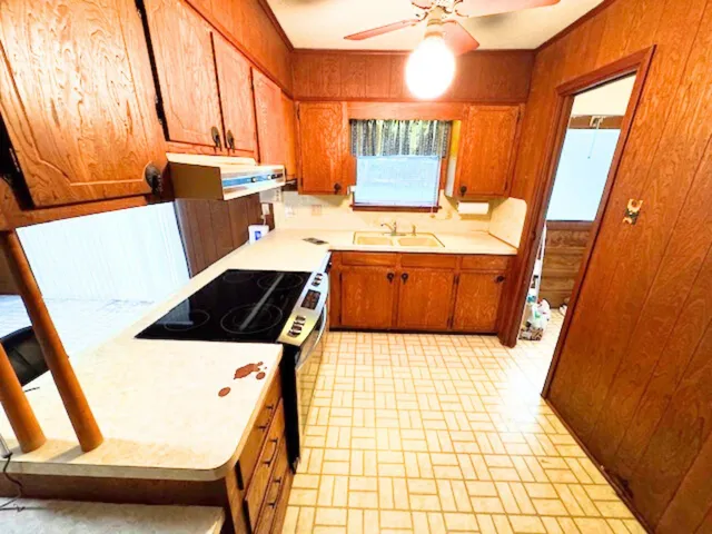 a kitchen with sink refrigerator and window