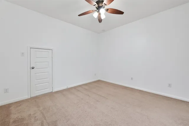 a view of a brick house with large windows