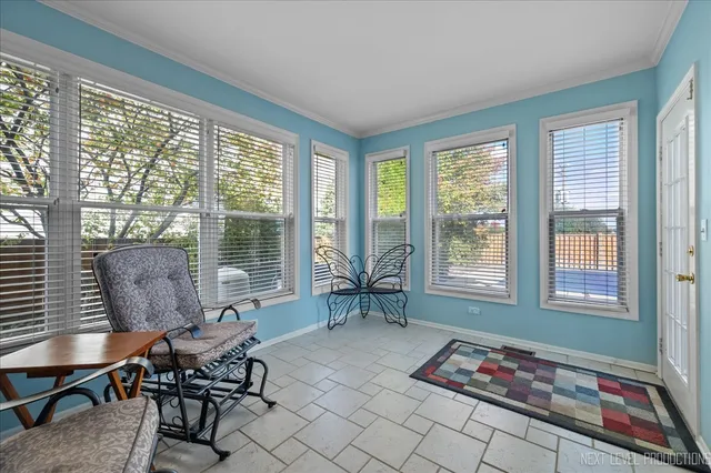 a living room with furniture and a floor to ceiling window