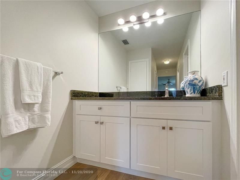 Limetree Condominiums Boynton Beach, FL 33436 - Photo 21 of 45 Lovely vanity with plenty of storage and granite counter in this remodeled Owner's Suite. Notice the generous sized Linen closet reflected in the mirror.