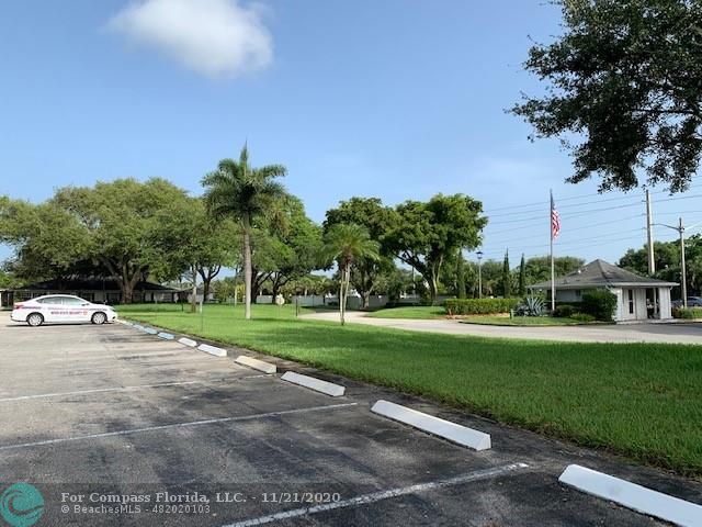 Limetree Condominiums Boynton Beach, FL 33436 - Photo 30 of 45 View of Limetree's single entrance and exit, from the clubhouse parking area and green-space.