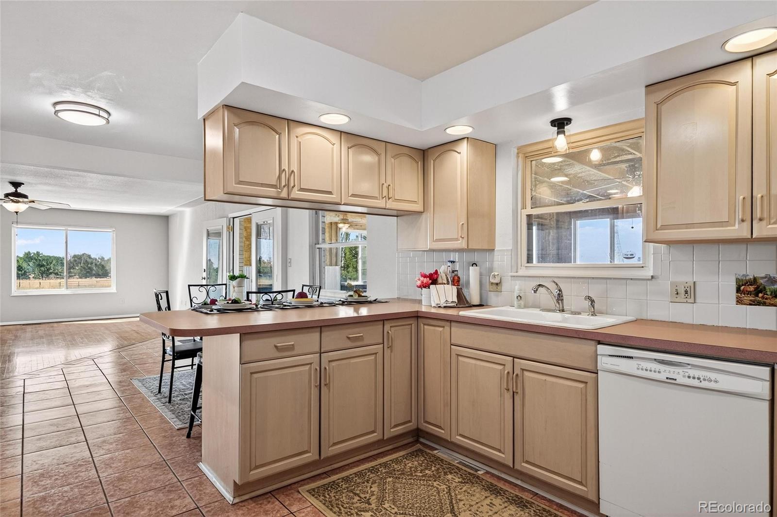 2869 Mathews Avenue Fort Lupton, CO 80621 - Photo 12 of 49 a kitchen with a sink stove and cabinets