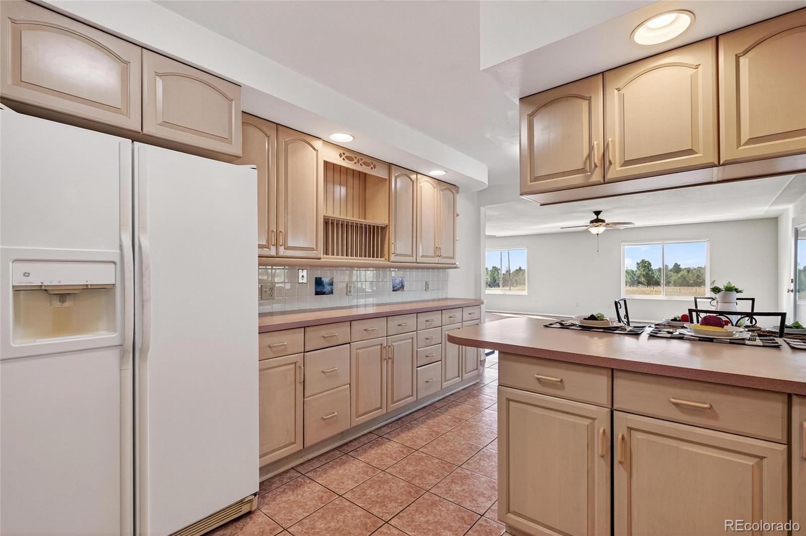 2869 Mathews Avenue Fort Lupton, CO 80621 - Photo 13 of 49 a kitchen with granite countertop cabinets stainless steel appliances a sink and a counter space