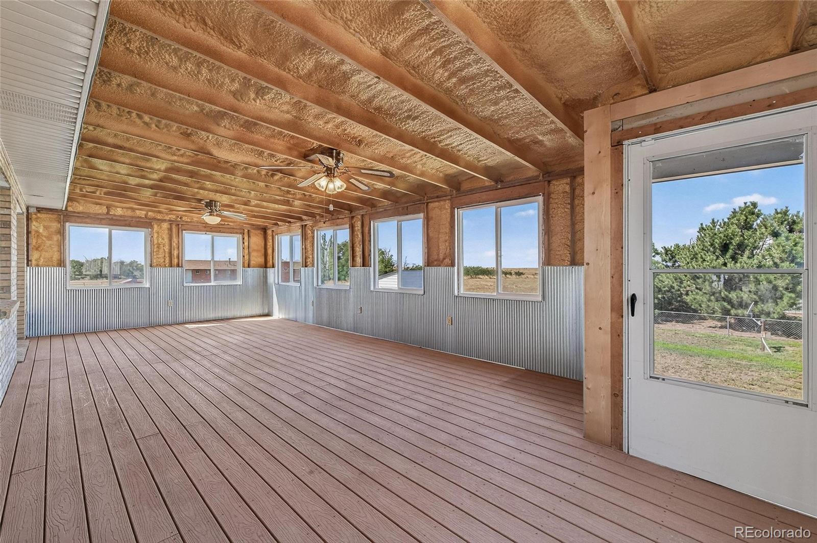 2869 Mathews Avenue Fort Lupton, CO 80621 - Photo 14 of 49 en empty room with wooden floor and windows