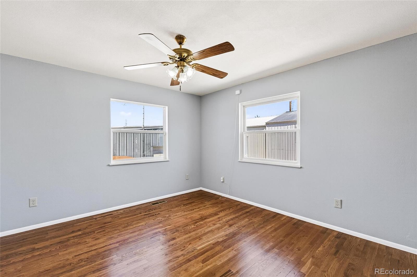 2869 Mathews Avenue Fort Lupton, CO 80621 - Photo 20 of 49 a view of a big room with wooden floor and windows