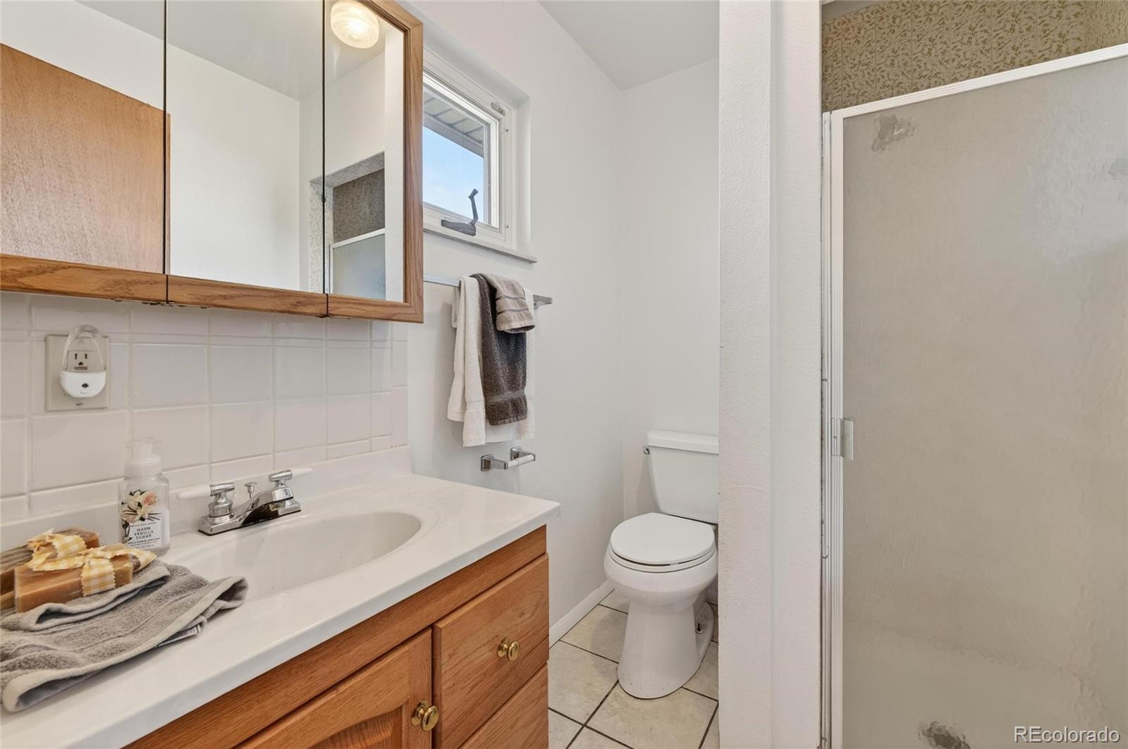 2869 Mathews Avenue Fort Lupton, CO 80621 - Photo 26 of 49 a bathroom with a sink toilet and vanity