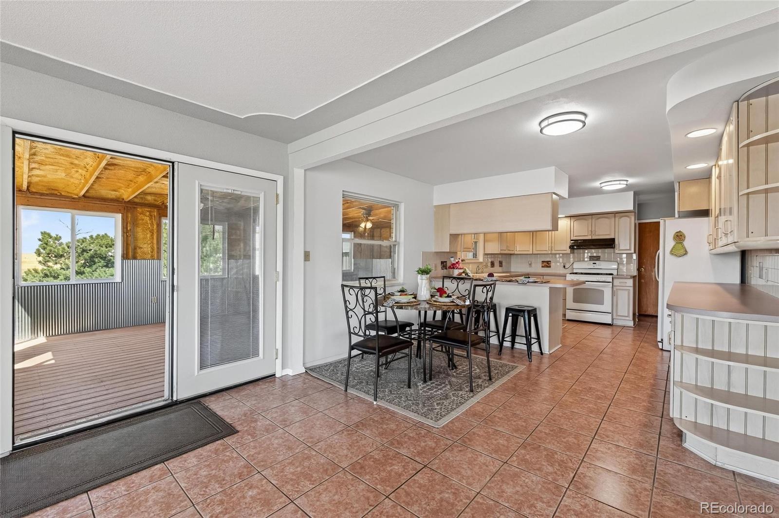 2869 Mathews Avenue Fort Lupton, CO 80621 - Photo 10 of 49 a dining hall with stainless steel appliances a dining table and chairs