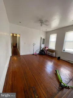 a view of a room with wooden floor and window