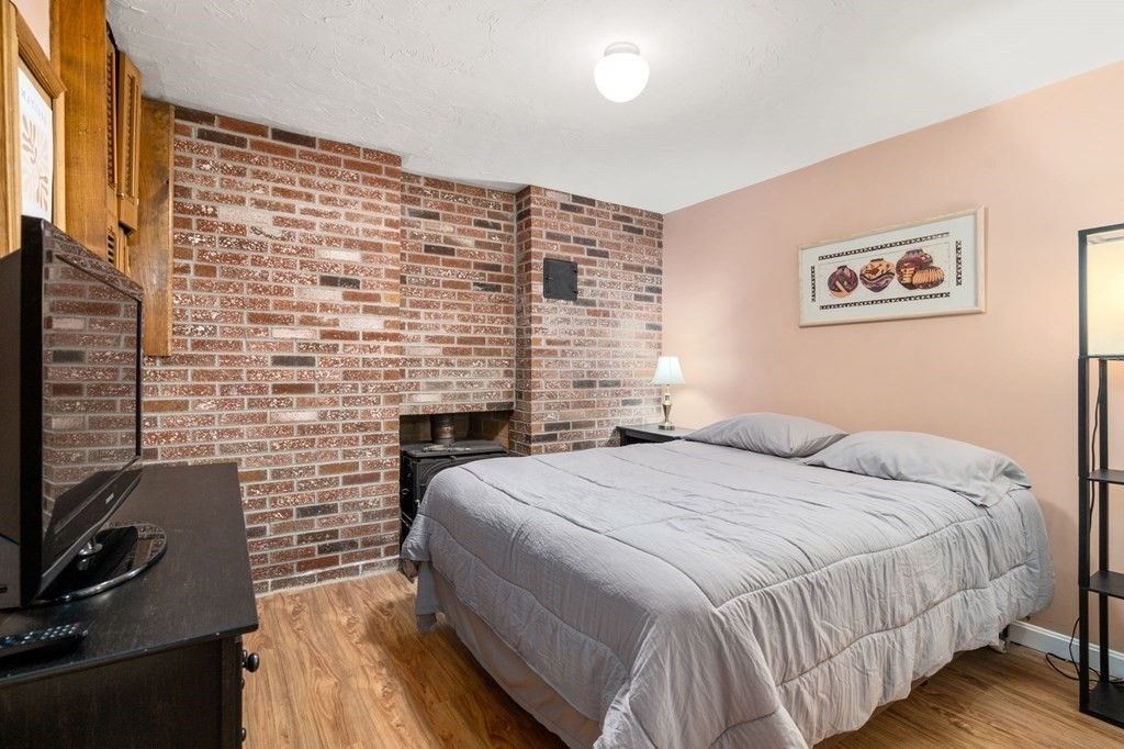 21 Summit Avenue Waltham, MA 02453 - Photo 12 of 19 a bedroom with a bed and a flat screen tv