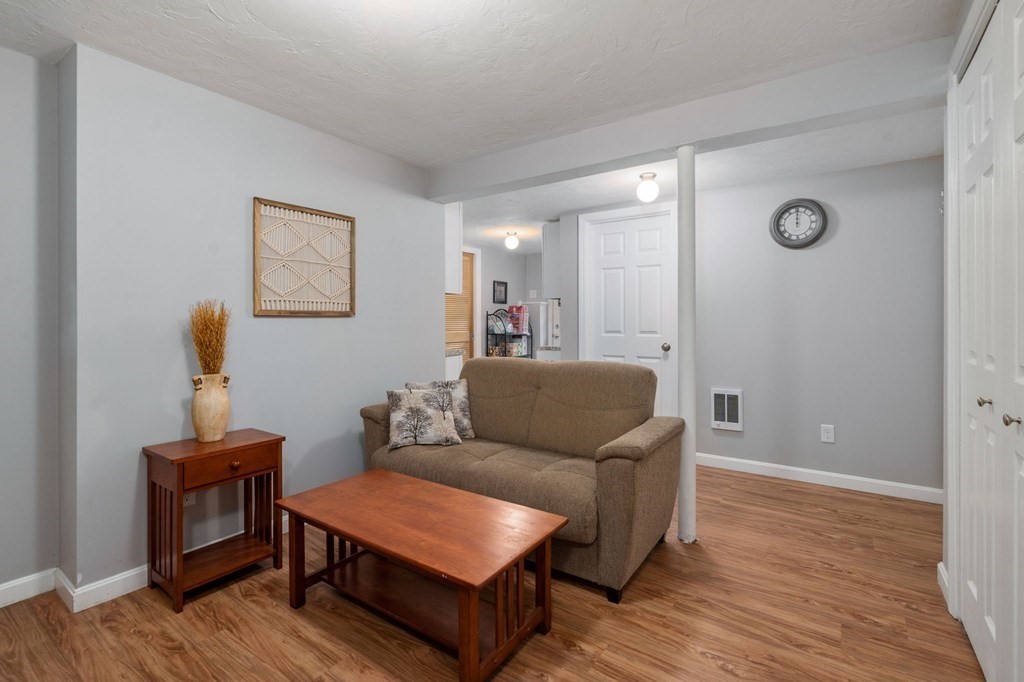 21 Summit Avenue Waltham, MA 02453 - Photo 14 of 19 a living room with furniture and a wooden floor