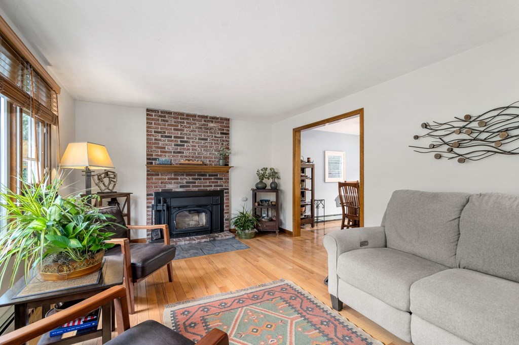21 Summit Avenue Waltham, MA 02453 - Photo 2 of 19 a living room with furniture and a fireplace