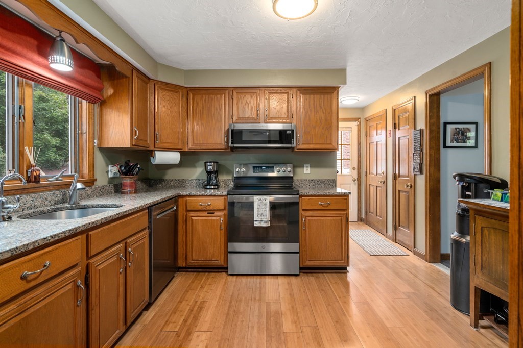 21 Summit Avenue Waltham, MA 02453 - Photo 3 of 19 a kitchen with stainless steel appliances granite countertop a stove a sink dishwasher a refrigerator and a oven