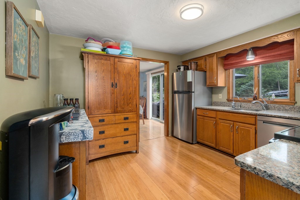 21 Summit Avenue Waltham, MA 02453 - Photo 4 of 19 a kitchen with granite countertop wooden cabinets and stainless steel appliances