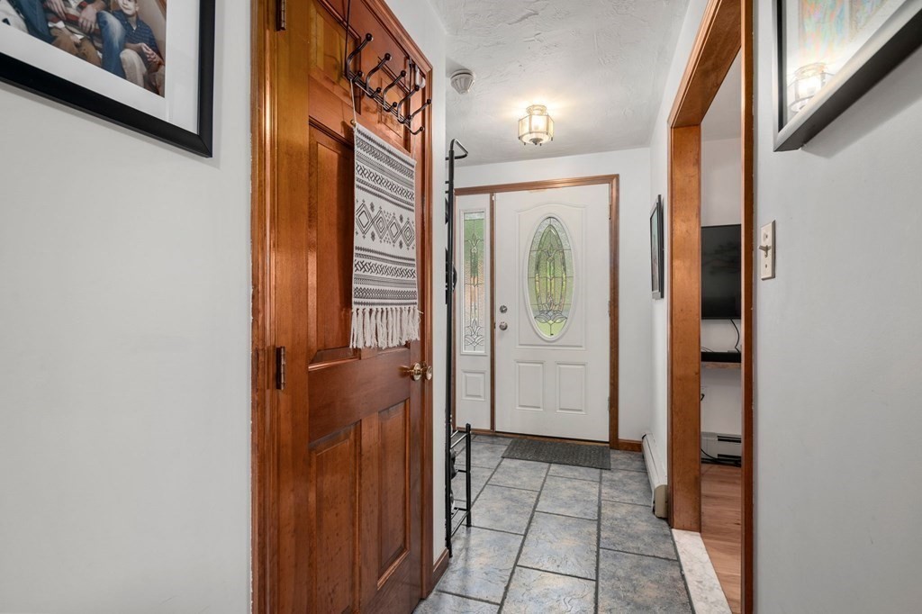 21 Summit Avenue Waltham, MA 02453 - Photo 6 of 19 a view of a hallway with wooden floor and closet