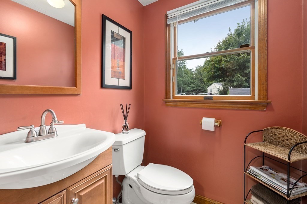 21 Summit Avenue Waltham, MA 02453 - Photo 7 of 19 a bathroom with a toilet a sink a mirror and a window