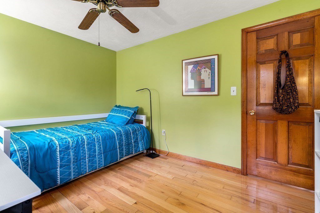 21 Summit Avenue Waltham, MA 02453 - Photo 9 of 19 a bedroom with a bed and wooden floor