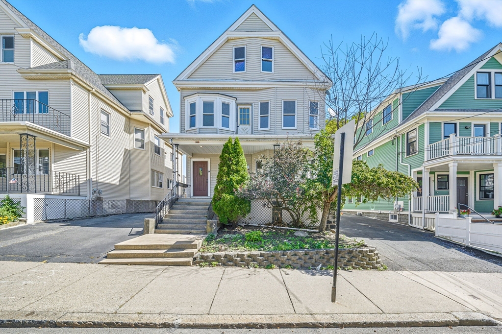 9 Curtis Street, Unit PKG Somerville, MA 02144 - Photo 1 of 2 a front view of a building with garden