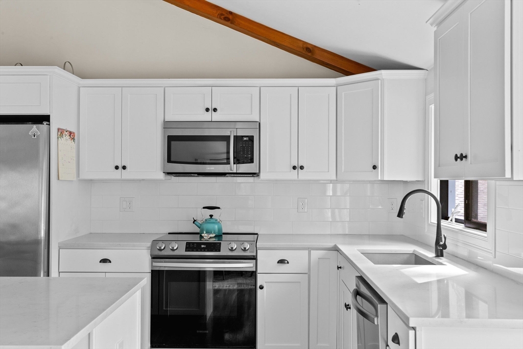 47 Pennfield Road Scituate, MA 02066 - Photo 11 of 27 a kitchen with stainless steel appliances granite countertop a sink a stove and a refrigerator with white cabinets