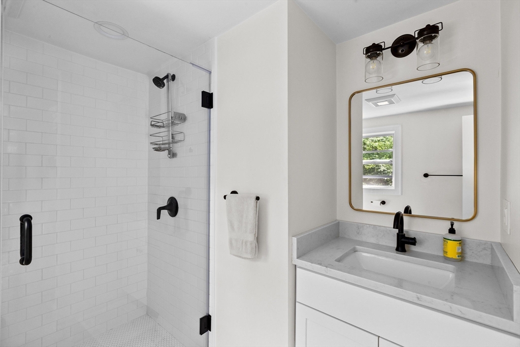 47 Pennfield Road Scituate, MA 02066 - Photo 17 of 27 a bathroom with a sink and a mirror