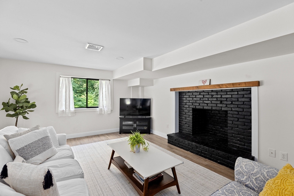 47 Pennfield Road Scituate, MA 02066 - Photo 20 of 27 a living room with furniture a rug and a fireplace