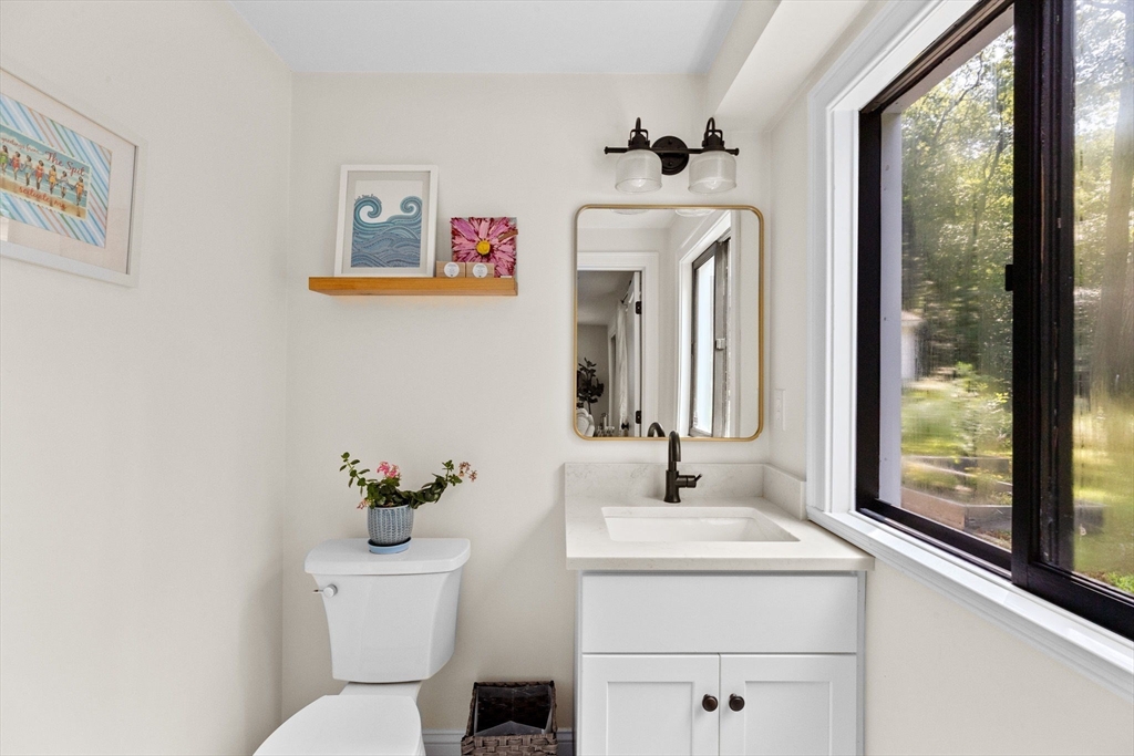 47 Pennfield Road Scituate, MA 02066 - Photo 21 of 27 a bathroom with a toilet sink and mirror