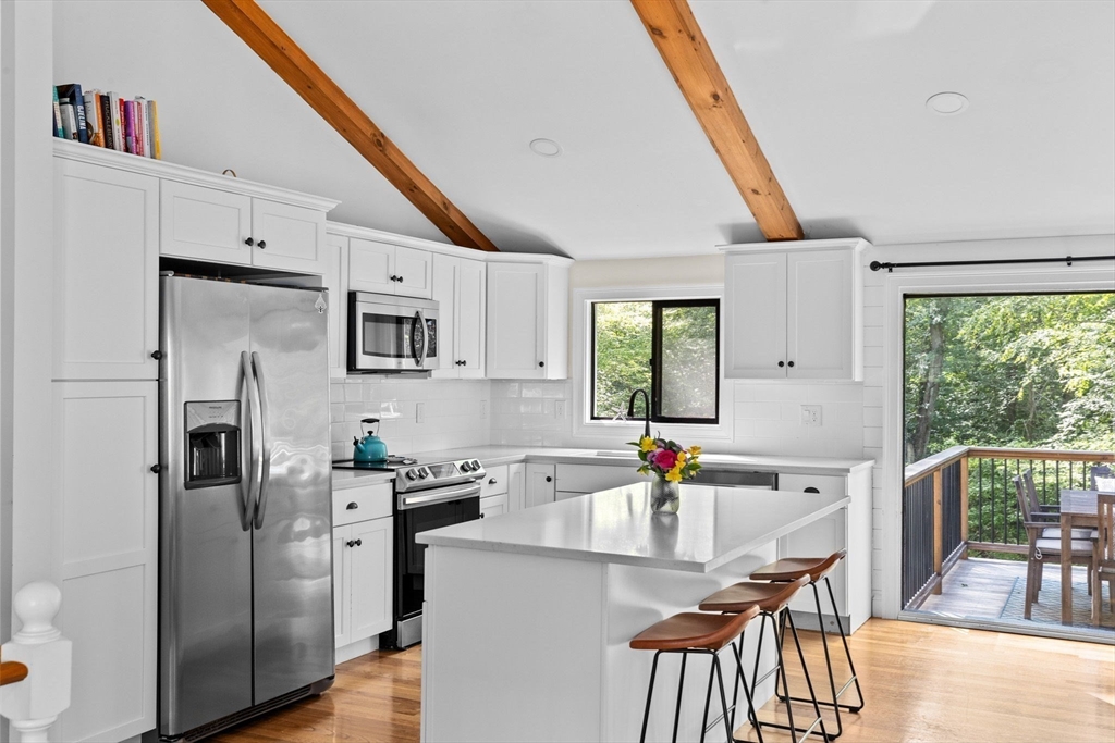 47 Pennfield Road Scituate, MA 02066 - Photo 9 of 27 a kitchen with stainless steel appliances a stove a sink dishwasher and a refrigerator
