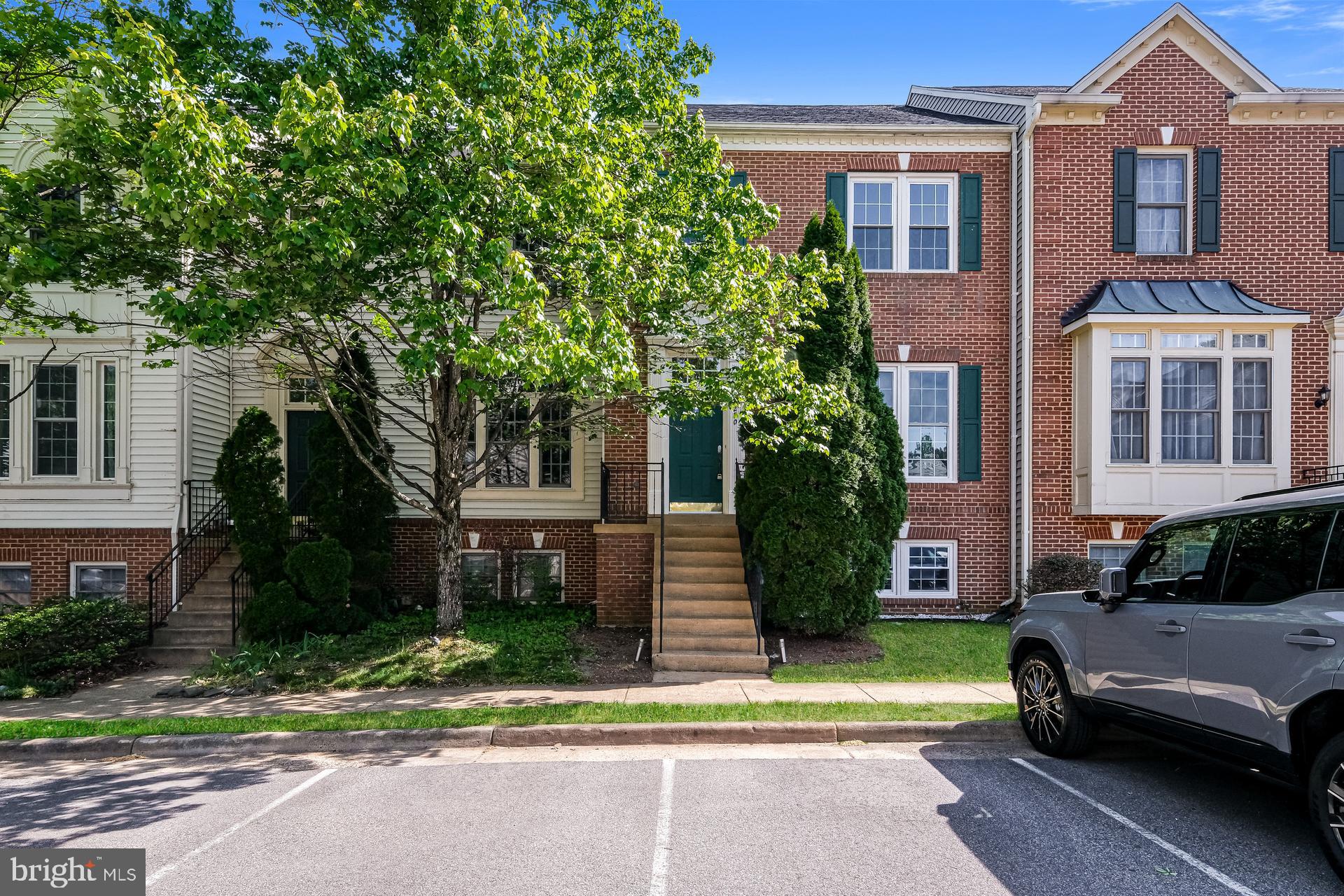 6270 Levi Court Springfield, VA 22150 - Photo 1 of 22 a view of a brick house with a yard plants and a large tree
