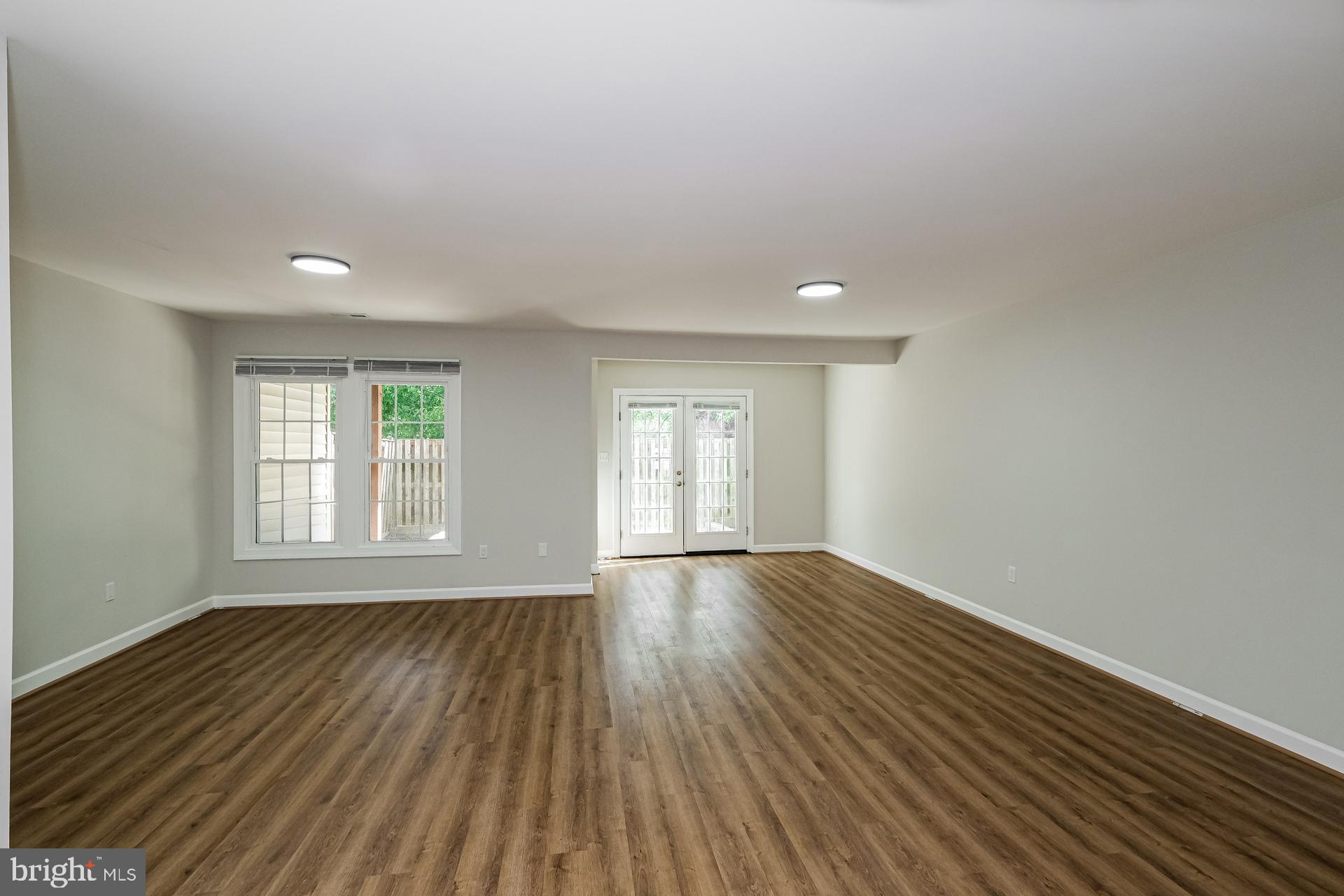 6270 Levi Court Springfield, VA 22150 - Photo 14 of 22 an empty room with wooden floor and windows
