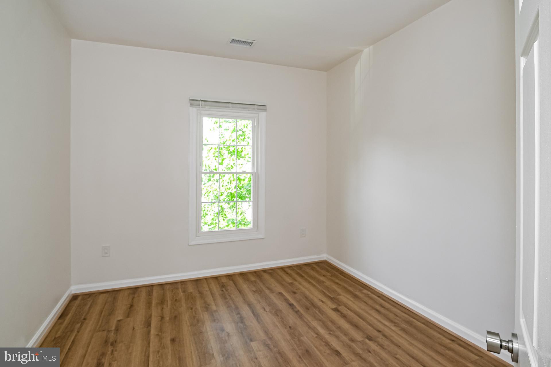 6270 Levi Court Springfield, VA 22150 - Photo 16 of 22 an empty room with wooden floor and windows