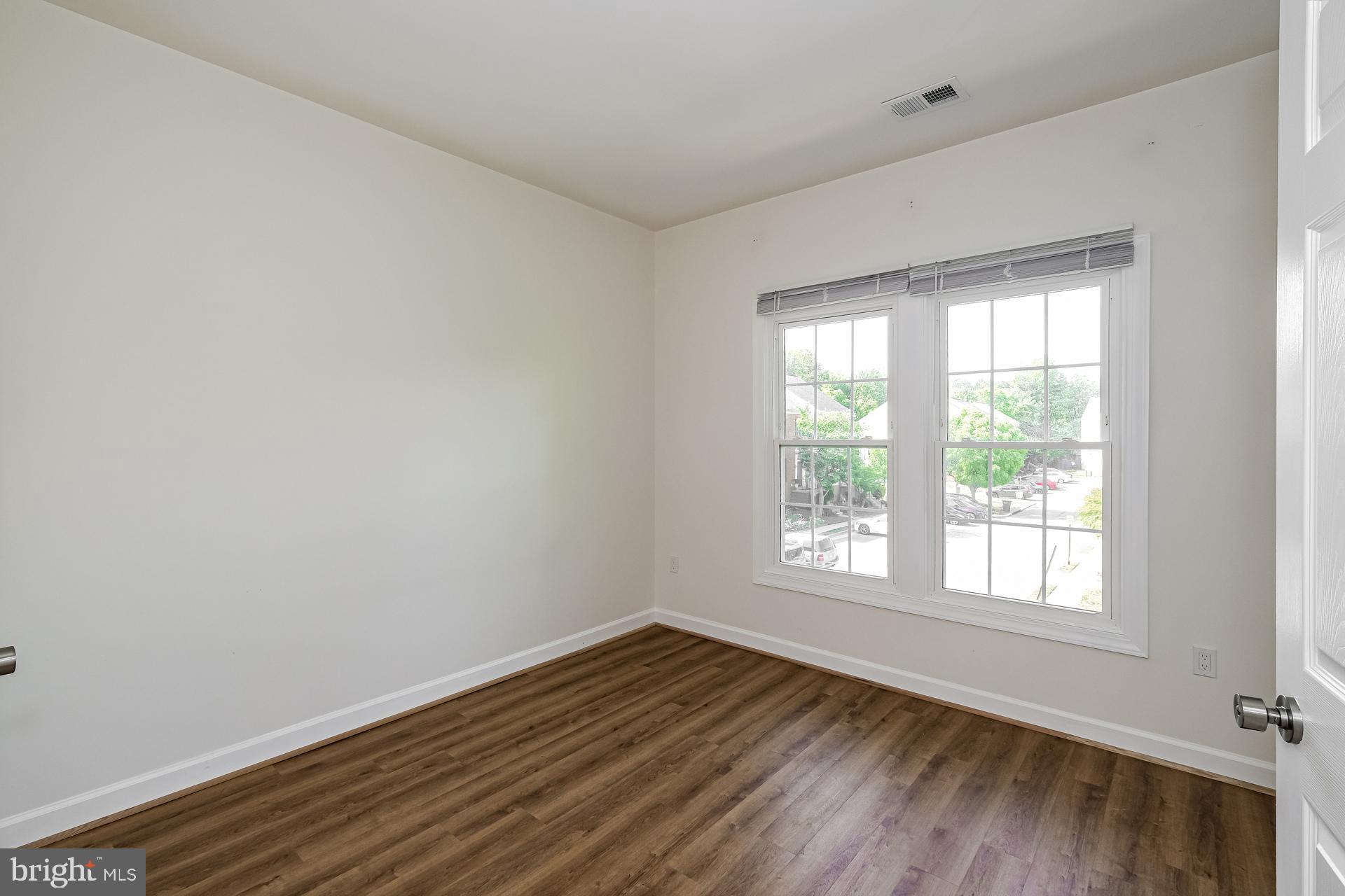 6270 Levi Court Springfield, VA 22150 - Photo 18 of 22 a view of an empty room with wooden floor and a window