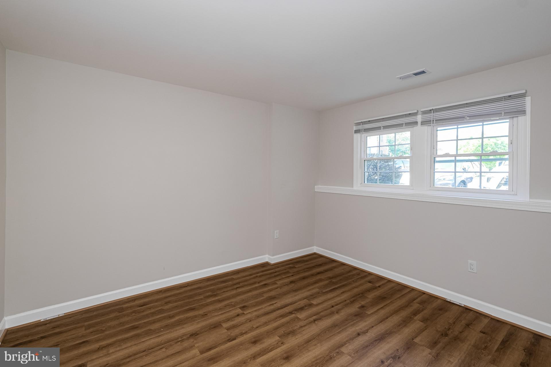 6270 Levi Court Springfield, VA 22150 - Photo 19 of 22 a view of a room with wooden floor and windows