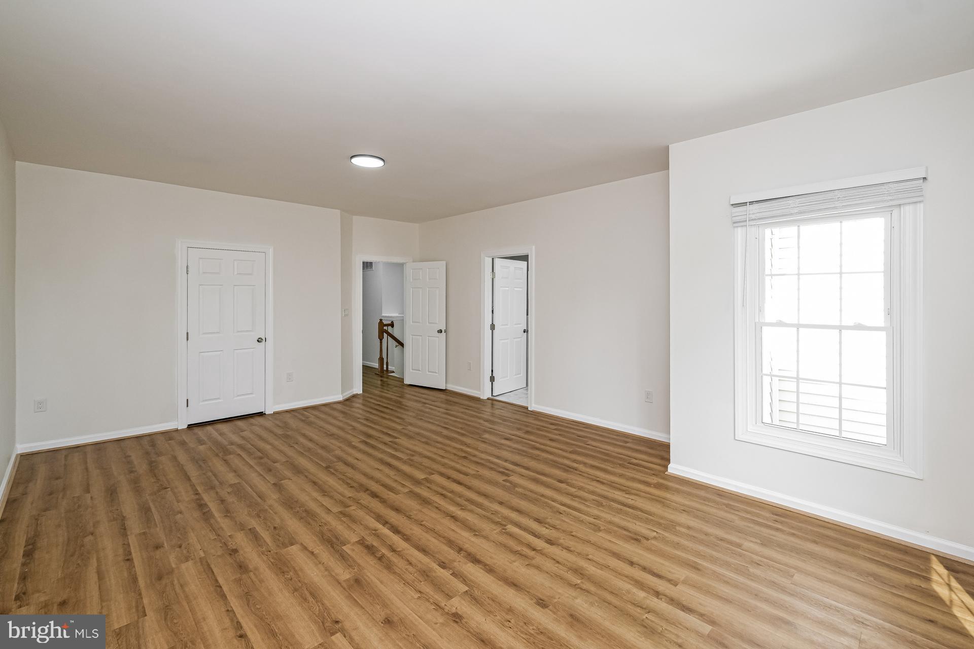 6270 Levi Court Springfield, VA 22150 - Photo 4 of 22 a view of empty room with wooden floor and fan