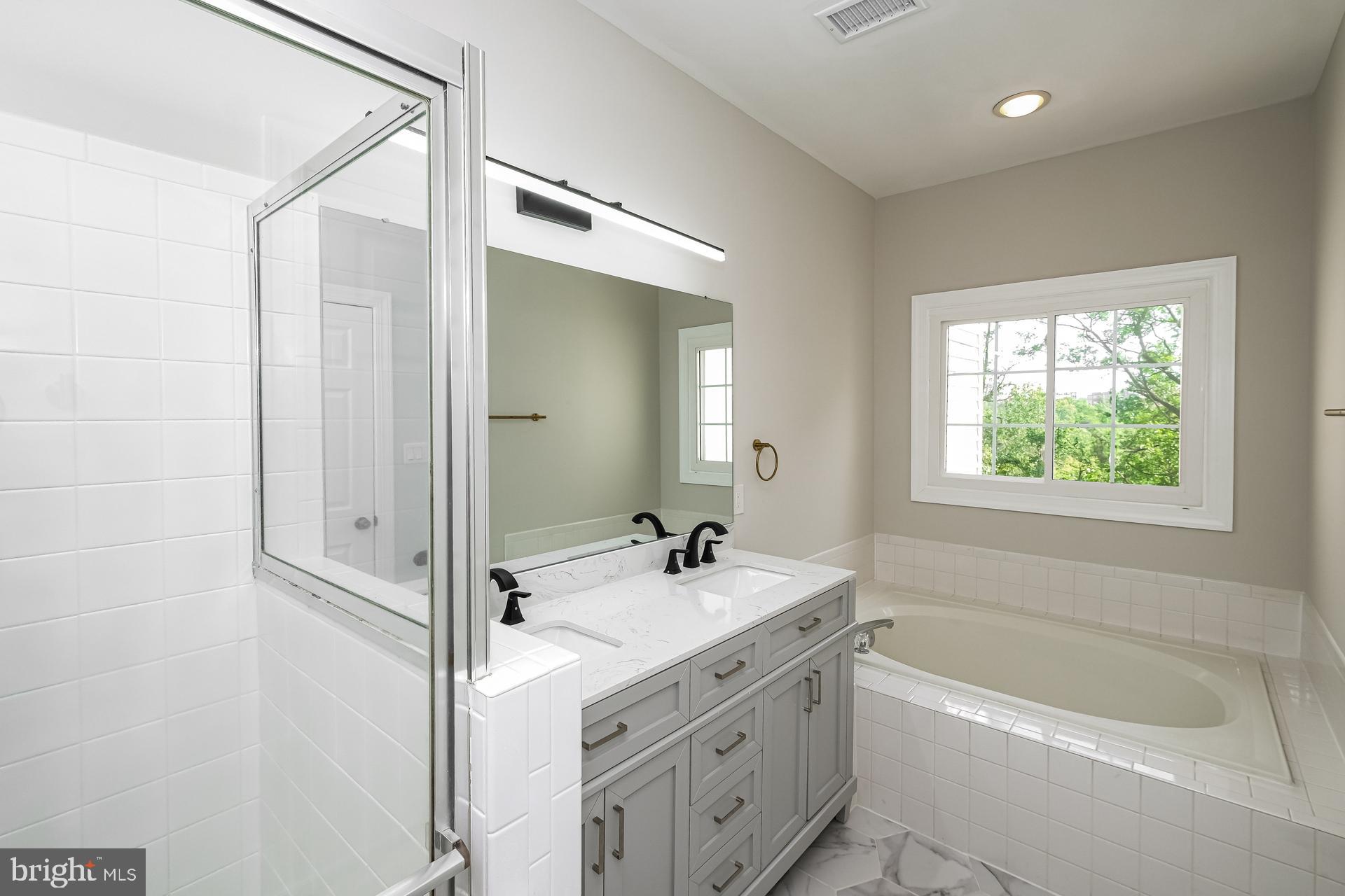 6270 Levi Court Springfield, VA 22150 - Photo 6 of 22 a bathroom with a tub sink and mirror