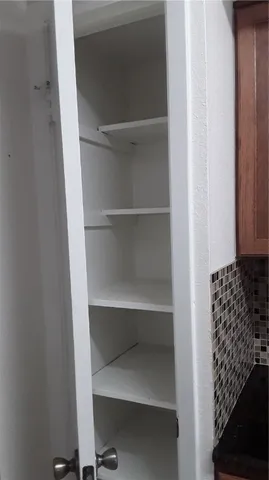a utility room with cabinets washer and dryer