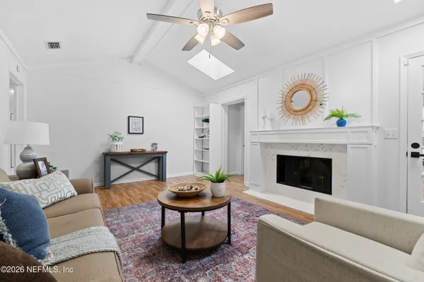 a living room with furniture and a fireplace