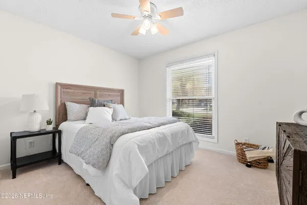 a bedroom with a bed and a window