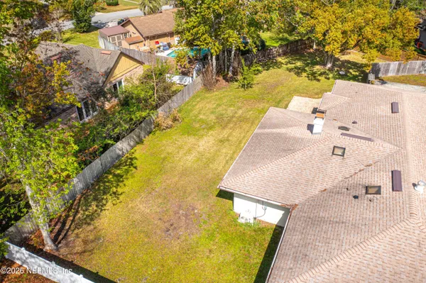 a view of a big yard next to a large tree