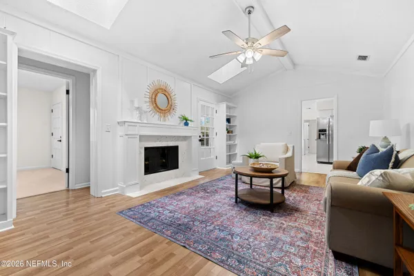 a living room with furniture and a fireplace