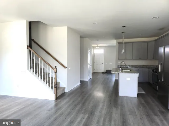 a view of a kitchen with wooden floor and electronic appliances