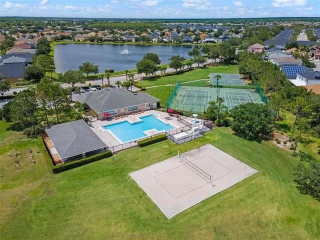 an aerial view of a house with garden space and a lake view