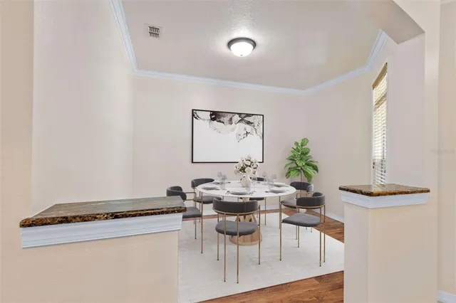 a dining room with furniture and wooden floor