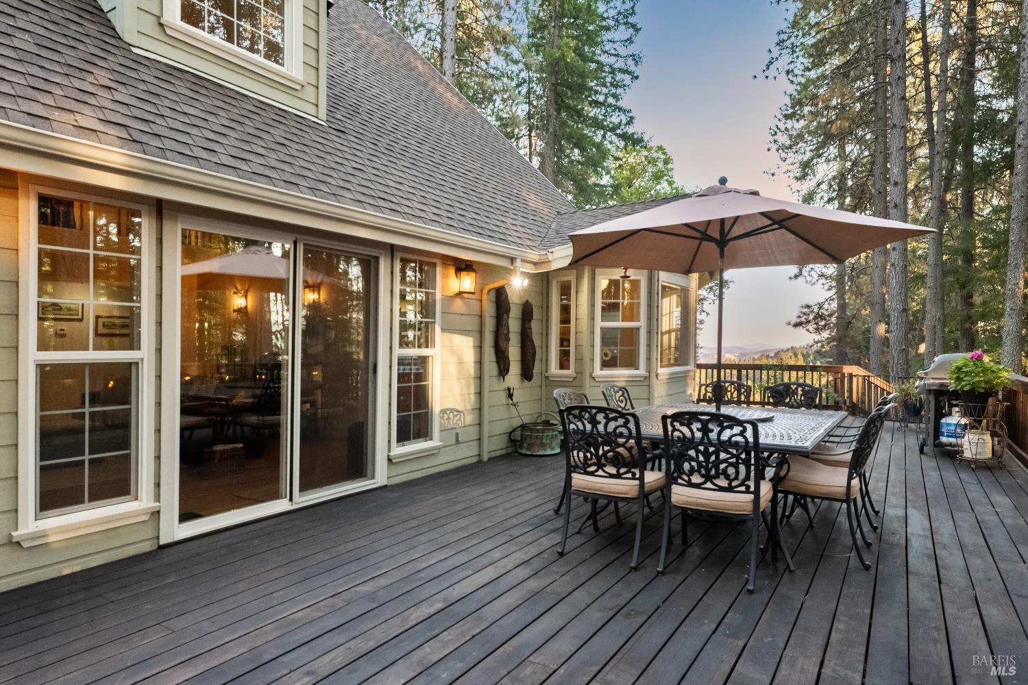 5701 Ridgewood Road Willits, CA 95490 - Photo 53 of 84 a view of a patio with table and chairs under an umbrella with wooden floor