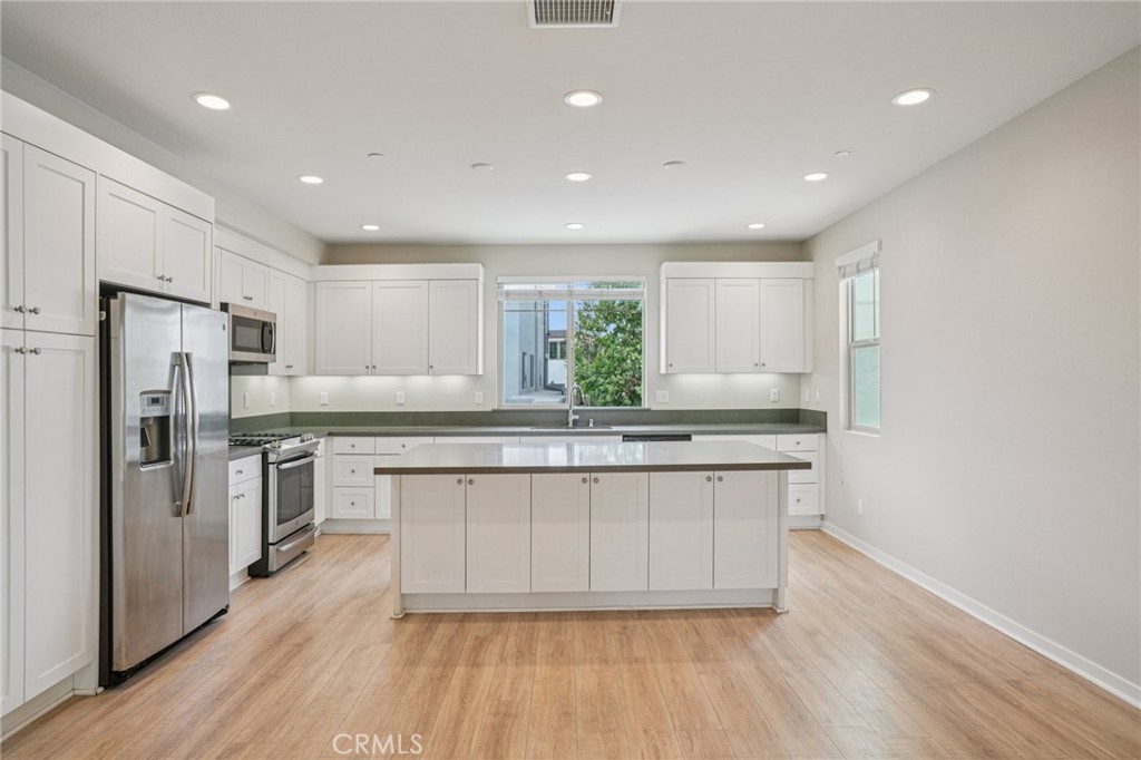 143 Frame Irvine, CA 92618 - Photo 3 of 41 a kitchen with stainless steel appliances granite countertop a stove a sink and a refrigerator