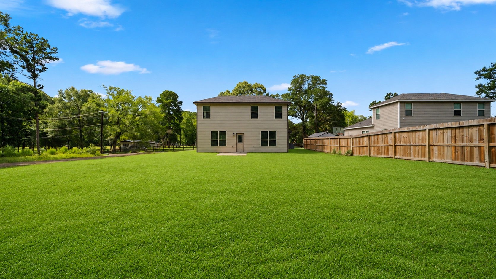18140 Mail Rte Road Montgomery, TX 77316 - Photo 22 of 26 View of the expansive, fully fenced backyard offering plenty of space for entertaining, pets, and outdoor activities.