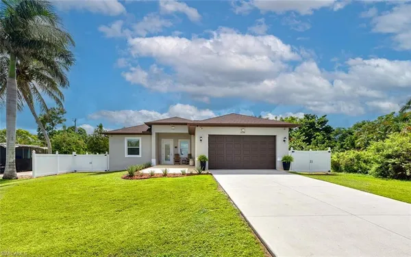 a front view of house with yard and green space