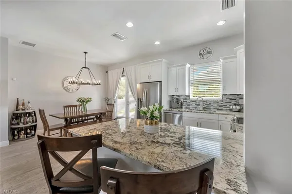 a kitchen with a table and chairs in it