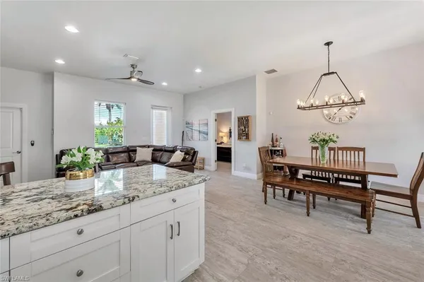 a view of living room with granite countertop furniture and wooden floor