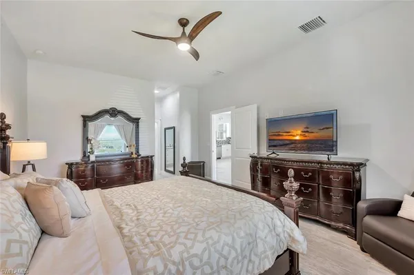 a bedroom with furniture and a flat screen tv